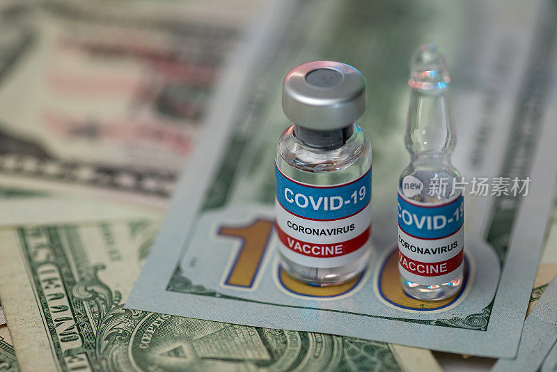关闭小瓶超过一堆美元- Covid-19疫苗接种的概念